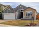 Charming single-Gathering home featuring stone accents, gray siding, and a well-manicured lawn at 11081 Cannonade Dr, Parker, CO 80138