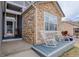 Charming front porch with rocking chairs, stone accents, and a welcoming entrance, perfect for relaxing at 11081 Cannonade Dr, Parker, CO 80138