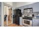 Well-lit kitchen with stainless steel appliances, ample cabinet space, and an adjacent doorway at 11081 Cannonade Dr, Parker, CO 80138