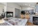 Open-concept kitchen and dining area featuring stainless steel appliances and a cozy fireplace at 11081 Cannonade Dr, Parker, CO 80138