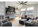 Inviting living room featuring a modern fireplace, large screen television, and comfortable seating at 11081 Cannonade Dr, Parker, CO 80138