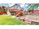 Home's backyard featuring a deck and terraced landscaping at 10517 Clermont Way, Thornton, CO 80233