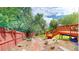 Landscaped backyard featuring a wooden deck and a garden area at 10517 Clermont Way, Thornton, CO 80233