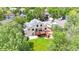 Aerial view of a home showcasing its backyard with a wooden deck, patio, and surrounding mature trees at 10517 Clermont Way, Thornton, CO 80233