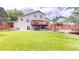 Spacious backyard with a wooden deck, lawn, and partial fence at 10517 Clermont Way, Thornton, CO 80233