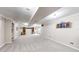 Large, carpeted basement area with ample open space at 10517 Clermont Way, Thornton, CO 80233