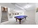 Spacious basement featuring a pool table and staircase at 10517 Clermont Way, Thornton, CO 80233