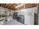 Unfinished basement space with laundry area and storage shelves at 10517 Clermont Way, Thornton, CO 80233