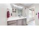 Bathroom featuring a vanity with a marble countertop and a large mirror with modern lighting at 10517 Clermont Way, Thornton, CO 80233