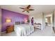 Bedroom showcasing the bed, ceiling fan, accent wall, and open closet at 10517 Clermont Way, Thornton, CO 80233