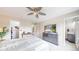 Bright bedroom featuring ceiling fan, furniture, and a television at 10517 Clermont Way, Thornton, CO 80233