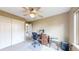 Bedroom featuring a ceiling fan, desk with computer, and sliding closet doors at 10517 Clermont Way, Thornton, CO 80233