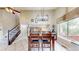 Cozy dining area filled with natural light, complemented by modern lighting fixtures above the table at 10517 Clermont Way, Thornton, CO 80233