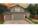 Charming two-story home featuring a well-manicured lawn and a spacious three-car garage at 10517 Clermont Way, Thornton, CO 80233