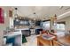 Well-lit kitchen with black cabinets, stainless steel appliances, and granite countertops at 10517 Clermont Way, Thornton, CO 80233
