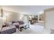 Spacious living room with plush carpeting, comfortable seating, and an open layout at 10517 Clermont Way, Thornton, CO 80233