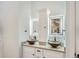 Bathroom with dual vessel sinks, backlit mirrors, and cabinet storage at 629 Copperdale Ln, Golden, CO 80401