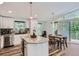 A bright kitchen featuring white cabinets, granite countertops, and stainless steel appliances at 629 Copperdale Ln, Golden, CO 80401