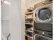 Efficient laundry area featuring stacked washer/dryer and convenient built-in shelving for storage at 629 Copperdale Ln, Golden, CO 80401