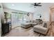 A living room with an L-shaped sofa, wood floors, and big bright windows at 629 Copperdale Ln, Golden, CO 80401