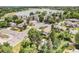 Aerial view of a property with a backyard pool, mature trees and community lake in the background at 10473 W Arkansas Dr, Lakewood, CO 80232