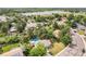 Stunning aerial view of property featuring a sparkling backyard pool and a beautiful lake in the background at 10473 W Arkansas Dr, Lakewood, CO 80232