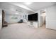 Spacious basement area with stairs, tv on console, stone fireplace and an adjacent bathroom at 10473 W Arkansas Dr, Lakewood, CO 80232