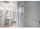 Bright bathroom featuring a pedestal sink, toilet and standing shower with glass door at 10473 W Arkansas Dr, Lakewood, CO 80232