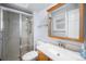 Bathroom with standing shower, toilet and vanity with an oval sink, mirror and medicine cabinet at 10473 W Arkansas Dr, Lakewood, CO 80232