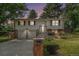 Charming two-story home with stone accents, a well-maintained lawn, and an inviting front entrance at 10473 W Arkansas Dr, Lakewood, CO 80232