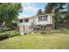 Traditional two-story house with a brick chimney and landscaping at 10473 W Arkansas Dr, Lakewood, CO 80232