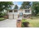Charming two-story home with a well-manicured lawn and stone accents at 10473 W Arkansas Dr, Lakewood, CO 80232