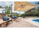 Outdoor patio featuring outdoor seating, lighting, landscaping and partial view of the pool at 10473 W Arkansas Dr, Lakewood, CO 80232