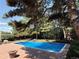 Enjoy this sparkling in-ground pool with a concrete surround that's perfect for relaxation and outdoor fun at 10473 W Arkansas Dr, Lakewood, CO 80232
