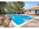 Backyard pool area featuring a diving board, rock feature, landscaping and a fenced perimeter at 10473 W Arkansas Dr, Lakewood, CO 80232