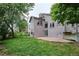 Relaxing backyard features a concrete patio and lush green lawn, perfect for outdoor entertaining at 9036 W Wisconsin Ave, Lakewood, CO 80232