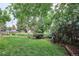 A backyard featuring a lush lawn, mature trees, and established landscaping at 9036 W Wisconsin Ave, Lakewood, CO 80232