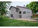 Cozy backyard patio offers a serene space, enhanced by the home's muted siding and well-maintained lawn at 9036 W Wisconsin Ave, Lakewood, CO 80232