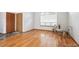 Bright bedroom featuring natural light and hardwood floors with a view of two doors in the background at 9036 W Wisconsin Ave, Lakewood, CO 80232