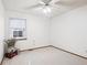 Neutral bedroom features a ceiling fan, window, and minimal decorations at 9036 W Wisconsin Ave, Lakewood, CO 80232