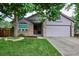 Charming single-Gathering home featuring a well-manicured front yard, mature trees, and a brick-accented facade at 9036 W Wisconsin Ave, Lakewood, CO 80232