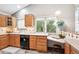 Well-lit kitchen with light wood cabinets and modern appliances at 9036 W Wisconsin Ave, Lakewood, CO 80232
