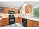 Stylish kitchen with black appliances and light wood cabinetry at 9036 W Wisconsin Ave, Lakewood, CO 80232