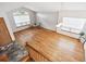 Spacious living room featuring hardwood floors, large windows, and modern pendant lighting at 9036 W Wisconsin Ave, Lakewood, CO 80232