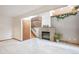 Cozy living room with a brick fireplace, staircase, and neutral carpet at 9036 W Wisconsin Ave, Lakewood, CO 80232
