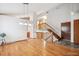 Open-concept living area featuring hardwood flooring and a staircase at 9036 W Wisconsin Ave, Lakewood, CO 80232