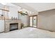 Bright living room with a brick fireplace and sliding glass doors to the outside at 9036 W Wisconsin Ave, Lakewood, CO 80232