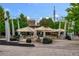 Outdoor seating area with tables, chairs, and umbrellas in a lively and inviting community space at 9036 W Wisconsin Ave, Lakewood, CO 80232