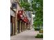 Charming Charlie shops line a pedestrian-friendly street with inviting storefronts and lush greenery at 9036 W Wisconsin Ave, Lakewood, CO 80232