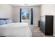 Well-lit bedroom with hardwood floors, and view of the outdoors at 9390 W Chatfield Pl # 108, Littleton, CO 80128